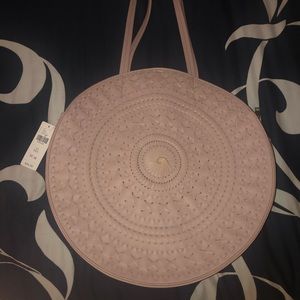 Round beige-pink Anthropologie purse. New with tags. Sun-dial stitch design.